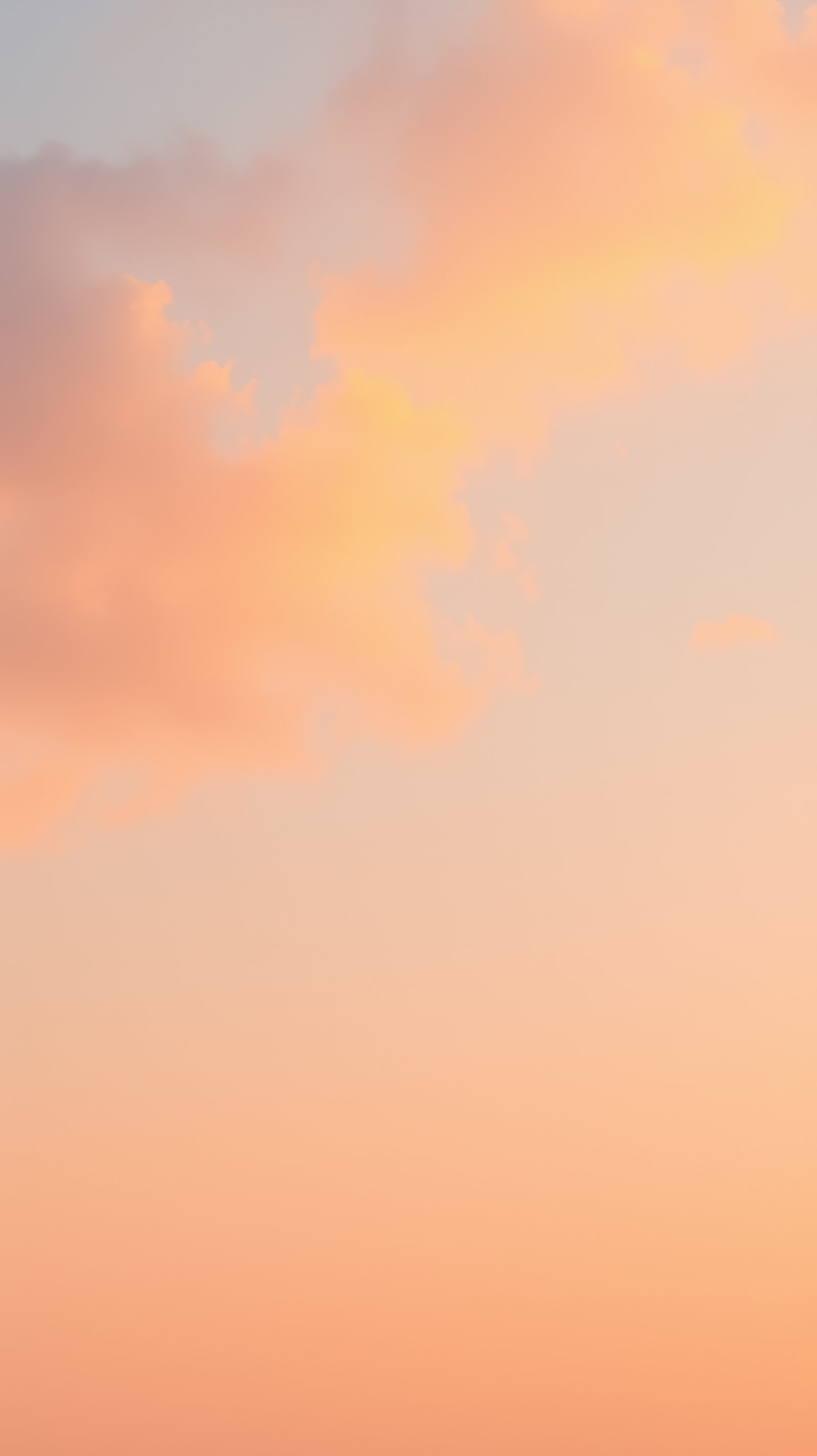 Colorful sunset sky with soft clouds over a tranquil horizon during evening hours in a serene landscape